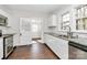 Beautiful kitchen with stainless steel appliances, granite countertops, white cabinets, and hardwood floors at 1101 Lancaster Ave, Monroe, NC 28112