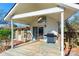 Cozy back porch with a grill, sliding glass doors to the home, and an adjacent stone wall at 112 Lentz St, Rockwell, NC 28138