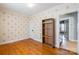 Bedroom featuring hardwood floors, decorative wallpaper, and a useful bookshelf at 112 Lentz St, Rockwell, NC 28138