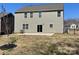 Exterior shot of back of house with sliding glass doors to patio in fenced backyard at 121 Edgehill Ct, Troutman, NC 28166