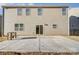 Rear exterior view of house with sliding glass door to backyard concrete patio at 121 Edgehill Ct, Troutman, NC 28166