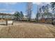 Spacious backyard featuring an expansive lawn, a concrete patio, and a secure fence at 121 Edgehill Ct, Troutman, NC 28166