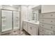 Bathroom featuring dual sink vanity, large mirror, tile flooring, and glass door shower at 121 Edgehill Ct, Troutman, NC 28166