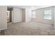 Spacious bedroom with carpet flooring and natural light from two windows at 121 Edgehill Ct, Troutman, NC 28166