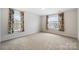 Carpeted bedroom with two windows offering natural light at 121 Edgehill Ct, Troutman, NC 28166