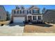 Charming two-story home with a brick facade, attached garage, and inviting front porch at 121 Edgehill Ct, Troutman, NC 28166