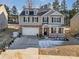 Beautiful two-story home featuring a brick facade, two-car garage, and well-manicured front yard at 121 Edgehill Ct, Troutman, NC 28166