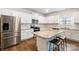 Close up of kitchen with white cabinetry, stainless steel appliances, granite countertops and island seating at 121 Edgehill Ct, Troutman, NC 28166