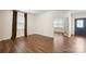 Living room featuring hardwood floors, two windows with curtains and a glass french door to the entry at 121 Edgehill Ct, Troutman, NC 28166
