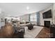Bright open-concept living room featuring a fireplace, hardwood floors, and lots of natural light at 121 Edgehill Ct, Troutman, NC 28166
