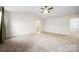 Spacious main bedroom features vaulted ceiling, ceiling fan, carpet flooring, and ensuite bathroom entrance at 121 Edgehill Ct, Troutman, NC 28166
