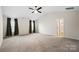 Spacious main bedroom features vaulted ceiling, ceiling fan, carpet flooring, and ensuite bathroom entrance at 121 Edgehill Ct, Troutman, NC 28166