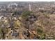 High-angle view of a neighborhood with homes surrounded by trees, roads, and a mix of residential buildings at 1216 Innis Ave, Kannapolis, NC 28081