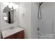 Bathroom with a round mirror and walk-in shower at 1216 Innis Ave, Kannapolis, NC 28081