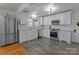 Bright kitchen featuring white cabinets, stainless steel appliances, subway tile backsplash, and gray tile floors at 1216 Innis Ave, Kannapolis, NC 28081