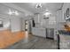 Bright kitchen with stainless steel appliances, white cabinets, and hardwood floors in the connected living area at 1216 Innis Ave, Kannapolis, NC 28081