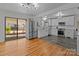 Open concept kitchen with white cabinetry, stainless steel appliances and an adjacent hardwood floor dining area at 1216 Innis Ave, Kannapolis, NC 28081