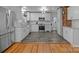 Updated kitchen featuring stainless steel appliances, white cabinets, and a brick accent wall at 1216 Innis Ave, Kannapolis, NC 28081
