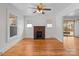 Bright living room with hardwood floors, a brick fireplace, and two windows offering natural light at 1216 Innis Ave, Kannapolis, NC 28081