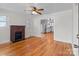 Open-concept room featuring hardwood floors, brick fireplace, and seamless access to an updated kitchen at 1216 Innis Ave, Kannapolis, NC 28081