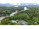Aerial view showcasing lakefront community, pool, and tennis courts surrounded by trees at 12702 Overlook Mountain Dr, Charlotte, NC 28216
