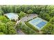 Aerial view of tennis court, parking, and community pool with lush landscaping at 12702 Overlook Mountain Dr, Charlotte, NC 28216