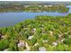 Stunning aerial view showcasing the lush landscape, mature trees, and lakefront homes in this desirable community at 12702 Overlook Mountain Dr, Charlotte, NC 28216