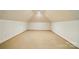 Finished attic space with carpet flooring, providing versatile room for storage or customization at 12702 Overlook Mountain Dr, Charlotte, NC 28216