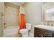 Cozy bathroom featuring a shower-tub combo and a wooden vanity sink, perfect for a starter home at 12702 Overlook Mountain Dr, Charlotte, NC 28216