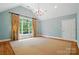 Well-lit bedroom with high ceilings, hardwood floors, large windows, and stylish chandelier at 12702 Overlook Mountain Dr, Charlotte, NC 28216