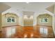 Versatile bonus room with hardwood floors, ample natural light, and unique architectural details at 12702 Overlook Mountain Dr, Charlotte, NC 28216