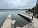 View of a private dock with boat lift access, and a covered boat house at 12702 Overlook Mountain Dr, Charlotte, NC 28216