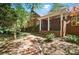 Brick home featuring a brick walkway, covered front porch, and beautiful landscaping at 12702 Overlook Mountain Dr, Charlotte, NC 28216