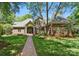 Charming brick home with a welcoming front porch and beautifully landscaped yard at 12702 Overlook Mountain Dr, Charlotte, NC 28216