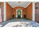 Inviting brick front entrance with elegant door, decorative accents, and manicured landscaping at 12702 Overlook Mountain Dr, Charlotte, NC 28216