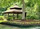 Gazebo in a common area with colorful flowers and landscaping at 12702 Overlook Mountain Dr, Charlotte, NC 28216