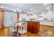 Bright kitchen with an island, custom cabinets, hardwood floors, and a cozy dining area at 12702 Overlook Mountain Dr, Charlotte, NC 28216