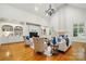 Bright living room with a fireplace, built-in shelving, hardwood floors, and elegant furnishings at 12702 Overlook Mountain Dr, Charlotte, NC 28216