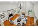 Spacious living room with high ceilings, fireplace, hardwood floors, and ample natural light, perfect for entertaining at 12702 Overlook Mountain Dr, Charlotte, NC 28216