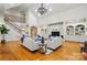 Spacious living room with a fireplace, staircase, hardwood floors, built-in shelving, and ample seating at 12702 Overlook Mountain Dr, Charlotte, NC 28216