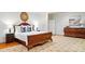 Bright main bedroom featuring wood accents, a sitting area, and a large mirror at 12702 Overlook Mountain Dr, Charlotte, NC 28216