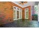 Charming outdoor brick patio features overhead fan and classic brick architecture at 12702 Overlook Mountain Dr, Charlotte, NC 28216