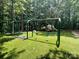 Community playground featuring swings and slide with padded ground cover at 12702 Overlook Mountain Dr, Charlotte, NC 28216