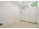 Well-lit utility room featuring white cabinets and neutral tile floors at 12702 Overlook Mountain Dr, Charlotte, NC 28216
