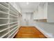 Large walk-in closet with custom shelving and hardwood floors, providing ample storage space at 12702 Overlook Mountain Dr, Charlotte, NC 28216