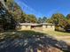 Charming stone home with a well-maintained lawn at 13828 Lake Bluff Dr, Matthews, NC 28105