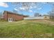 Spacious backyard featuring a brick house, green lawn and a privacy fence at 1443 Greenwood Rd, Lincolnton, NC 28092