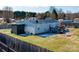 Aerial view of a home with a fenced-in backyard, a deck, and well-maintained landscaping at 1868 Ellick Dr, Newton, NC 28658