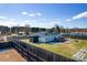 Aerial view of fenced backyard with a storage shed, deck, and lush lawn at 1868 Ellick Dr, Newton, NC 28658