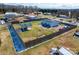 Aerial view of the property showcasing the home, fenced yard, outbuildings and outdoor recreational space at 1868 Ellick Dr, Newton, NC 28658